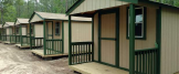 Wooden huts at Cedar Creek Resort